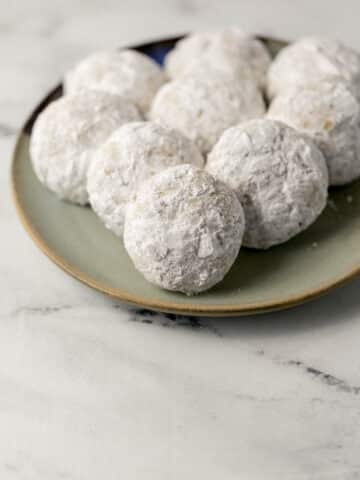 finished tea cakes covered in powdered sugar on a plate