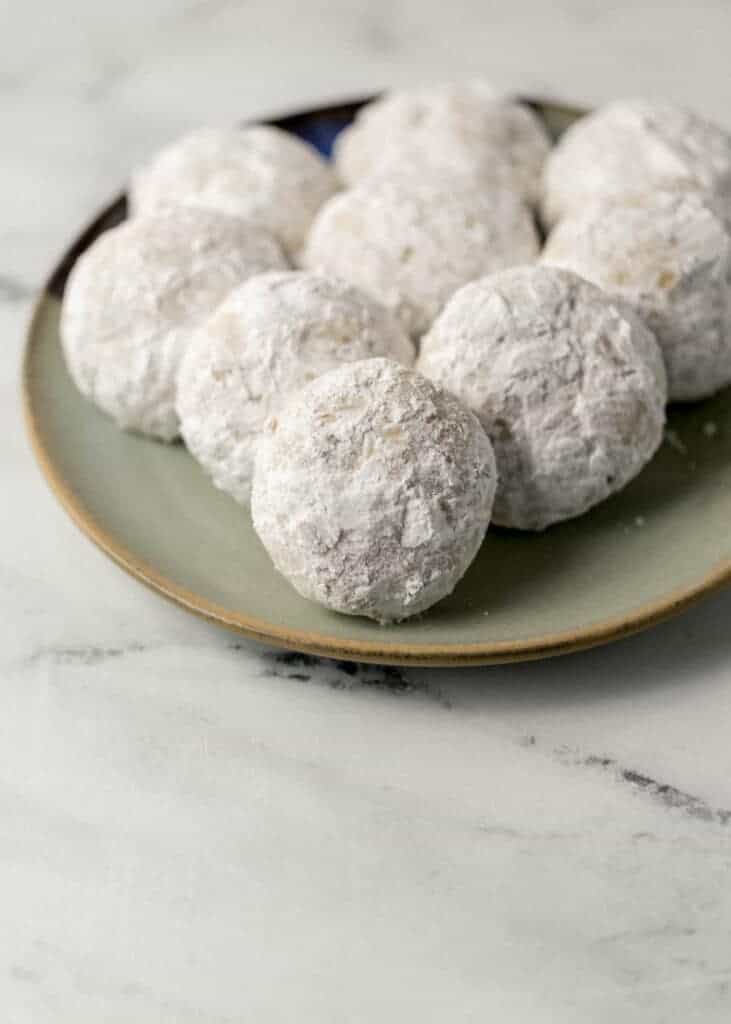 finished tea cakes covered in powdered sugar on a plate