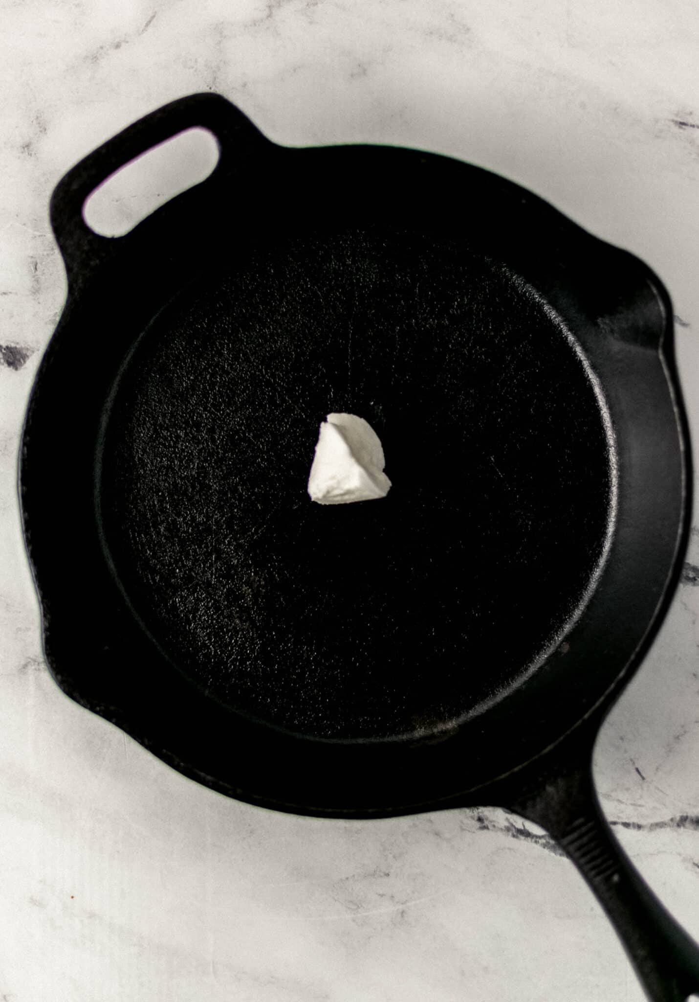 cast iron skillet with shortening in it