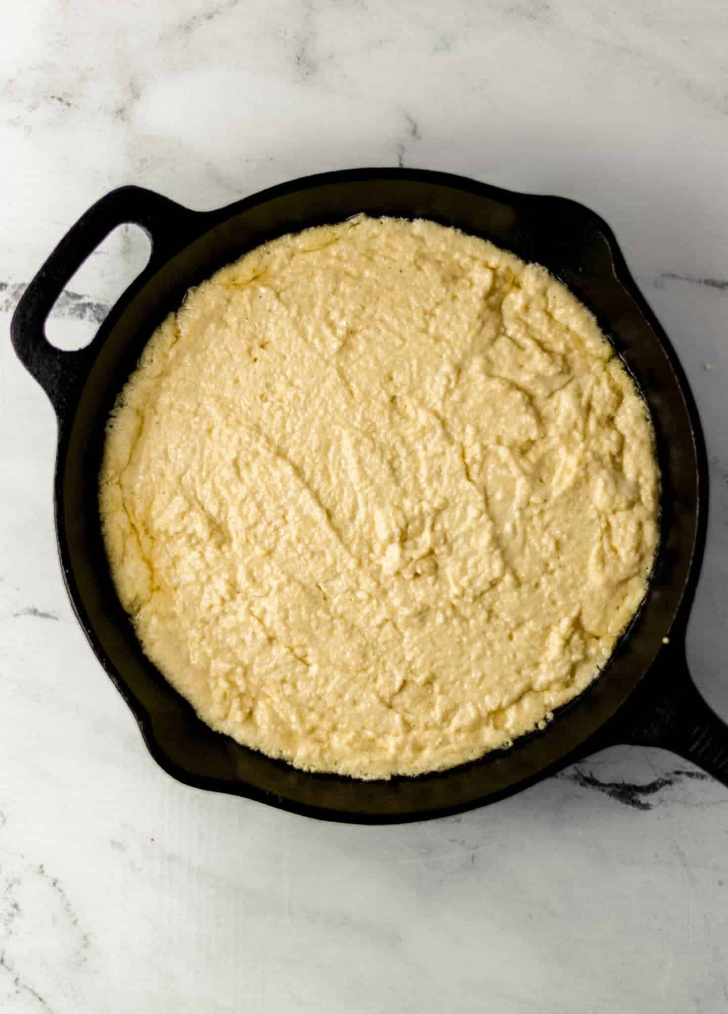 cornbread mixture added to preheat skillet