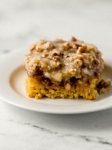 Close up view of piece of cake on a white plate.