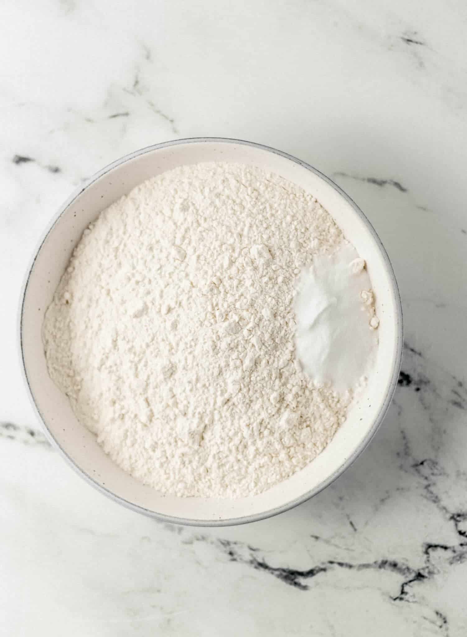 bowl with flour and baking soda in it 