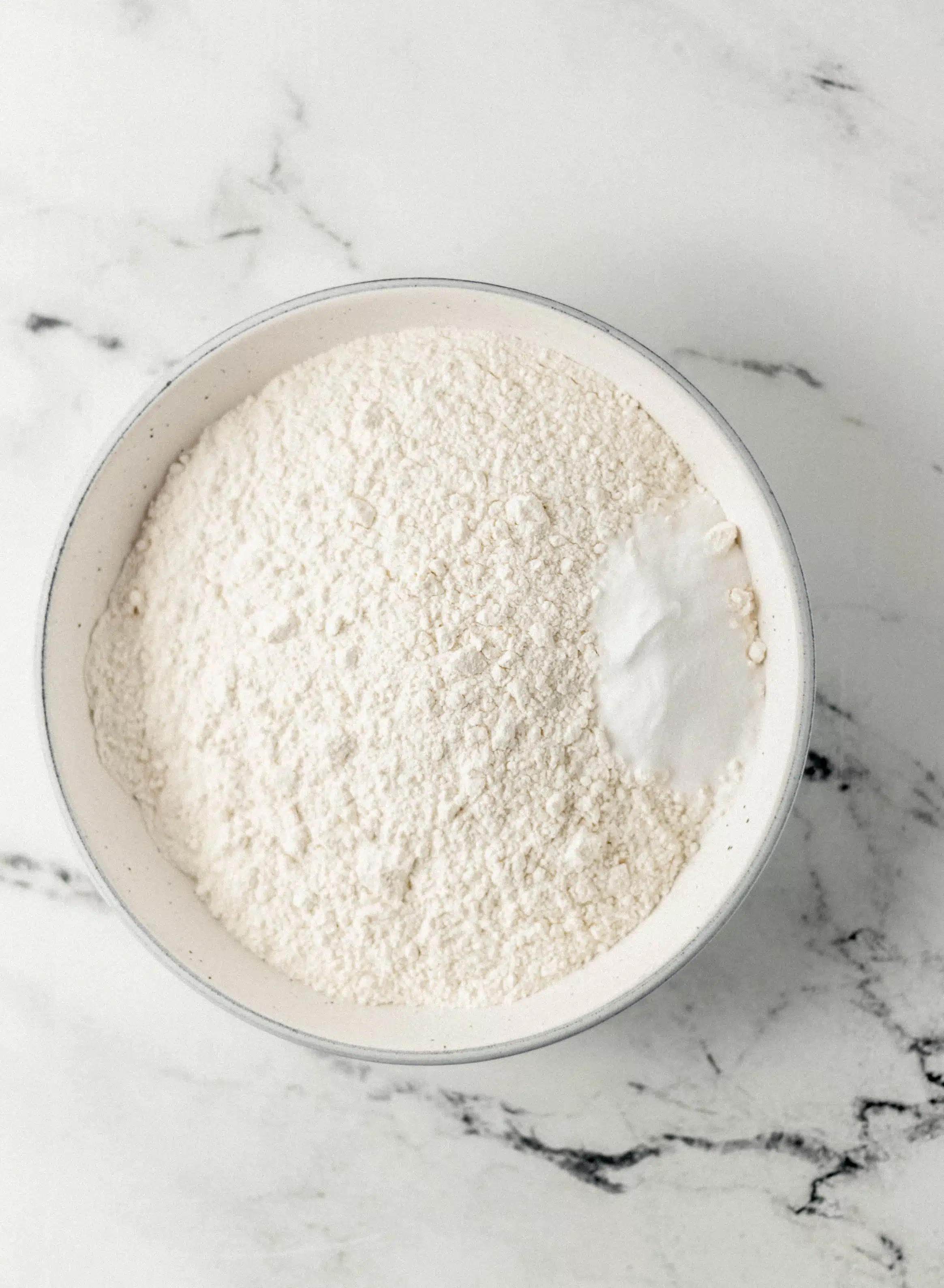 bowl with flour and baking soda in it 