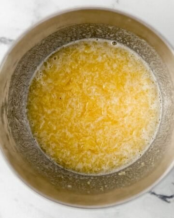 Overhead view of pineapple mixture in stand mixer bowl.