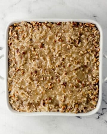 Icing added to the top of the cake in a baking dish.