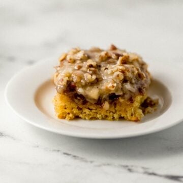 Close up side view of piece of cake on white plate.