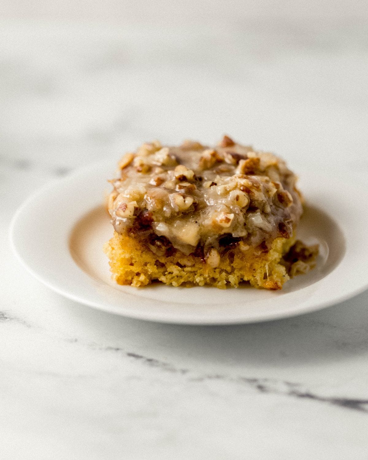 Close up side view of piece of cake on white plate.