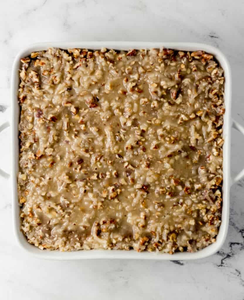 overhead view of finished cake topped with icing in baking dish