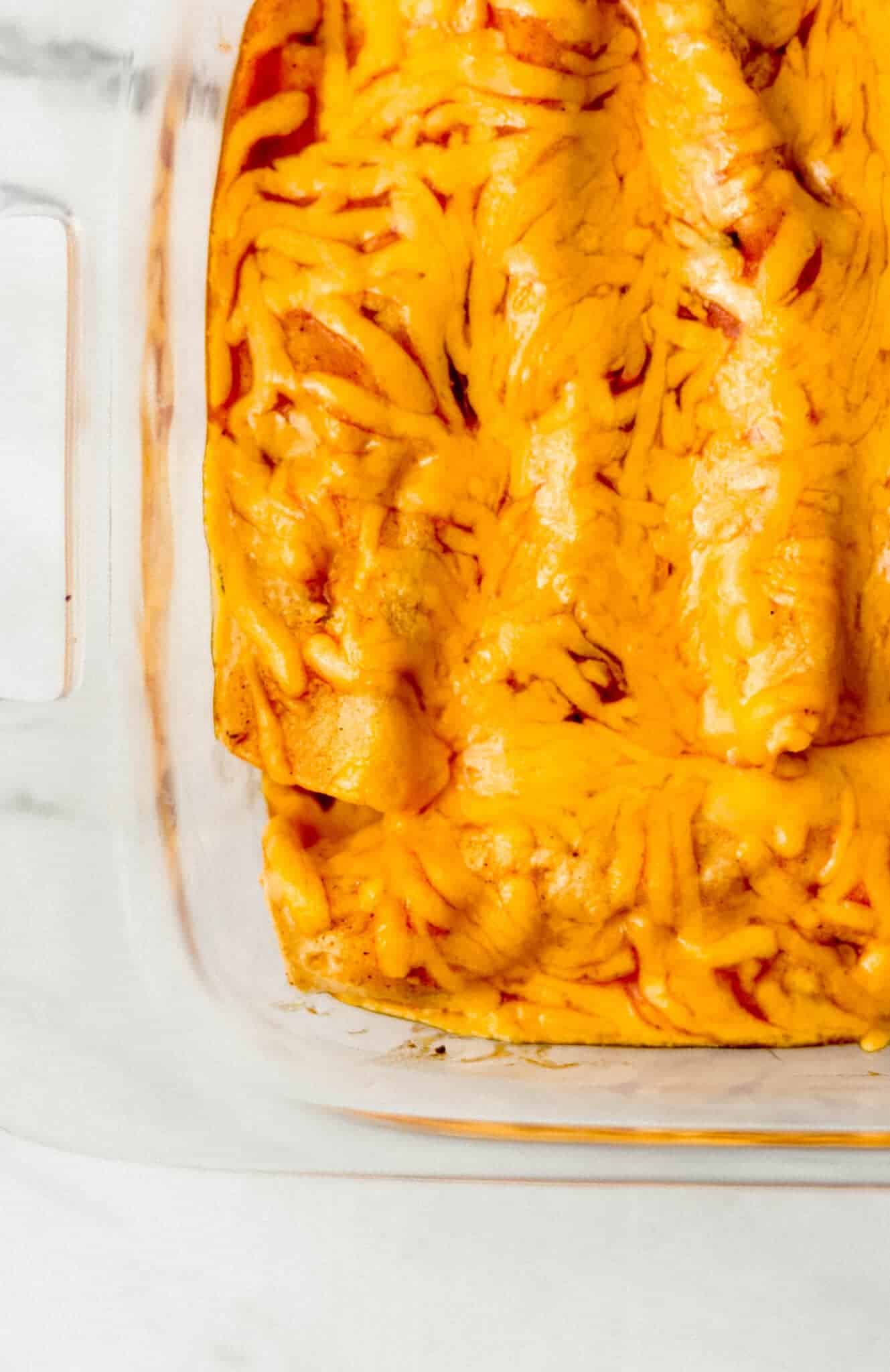 overhead view of finished enchiladas in glass baking dish 