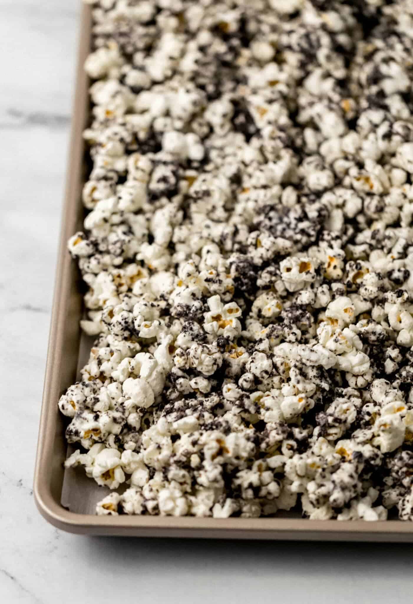 close up side view of finished popcorn on parchment lined baking sheet 