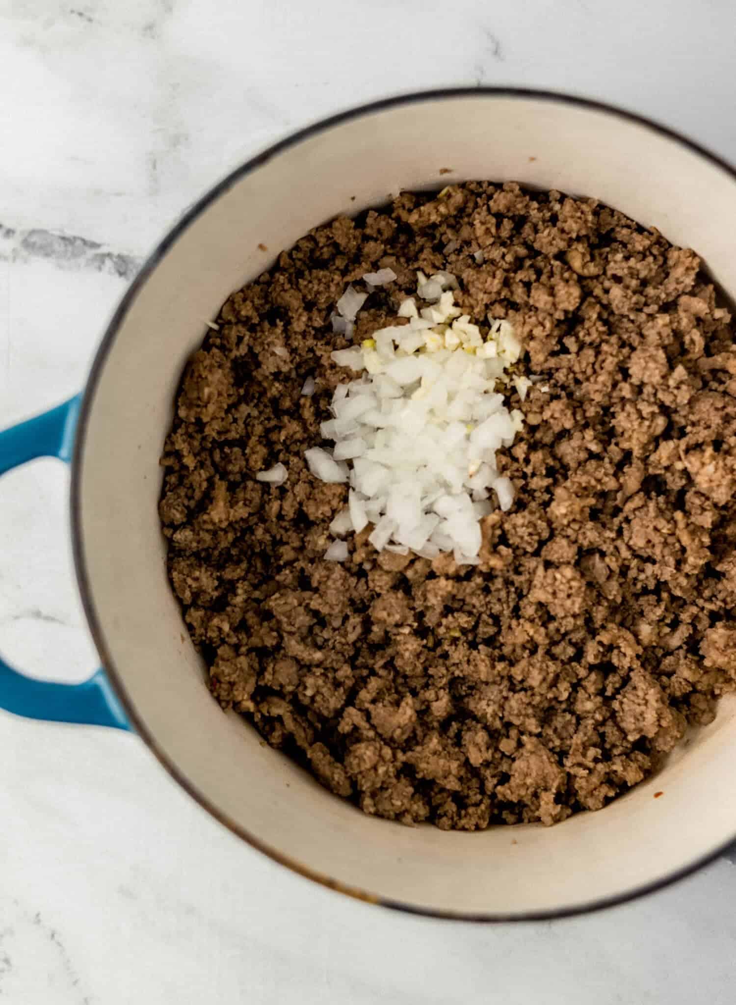 beef, sausage, onion, and garlic in large pot