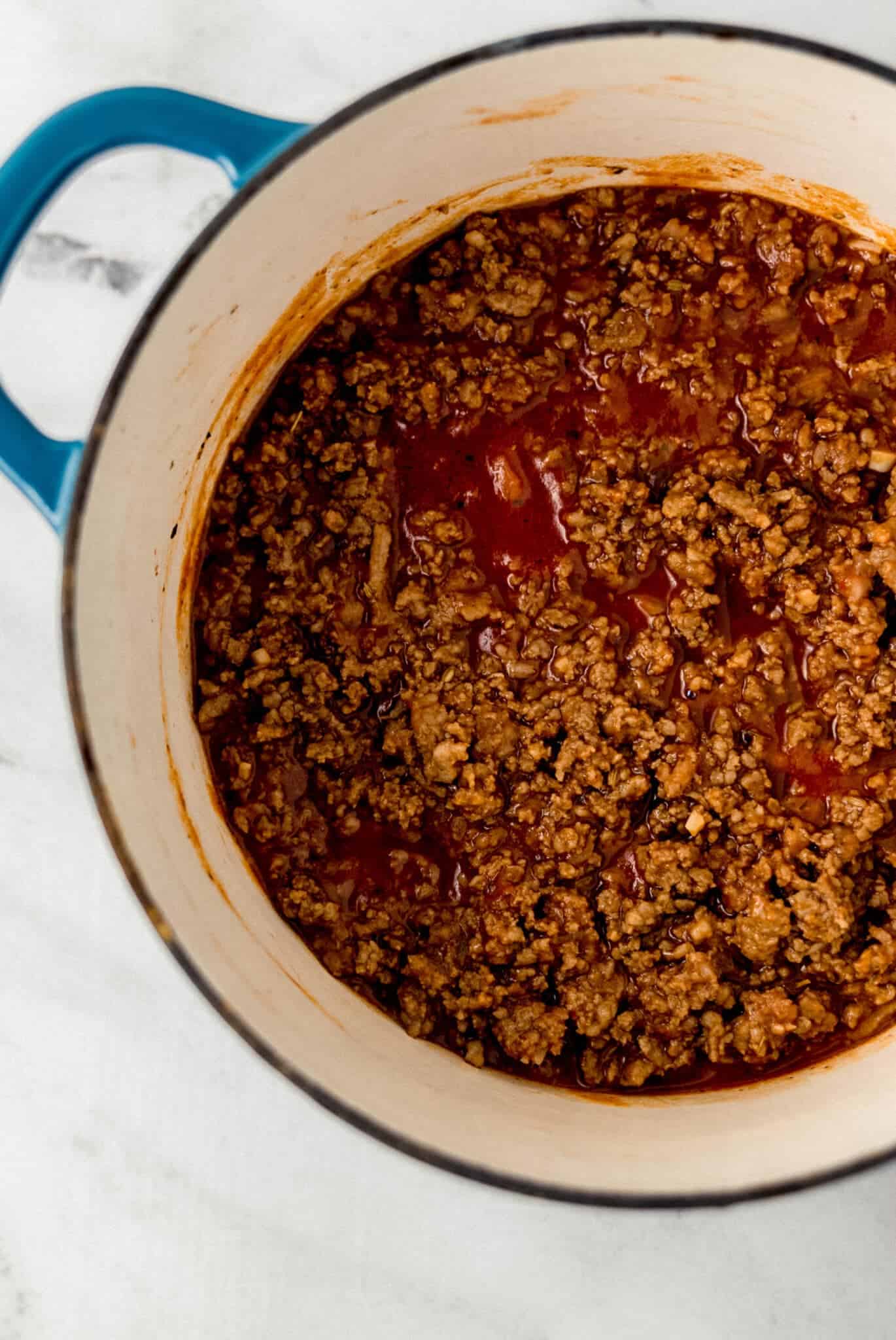 spaghetti sauce ingredients combined together in large pot