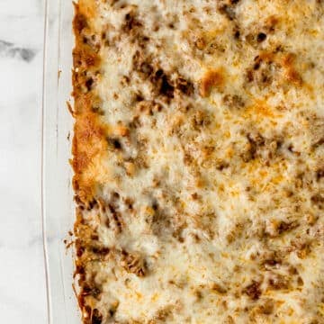 overhead view of finished baked spaghetti recipe in glass baking dish