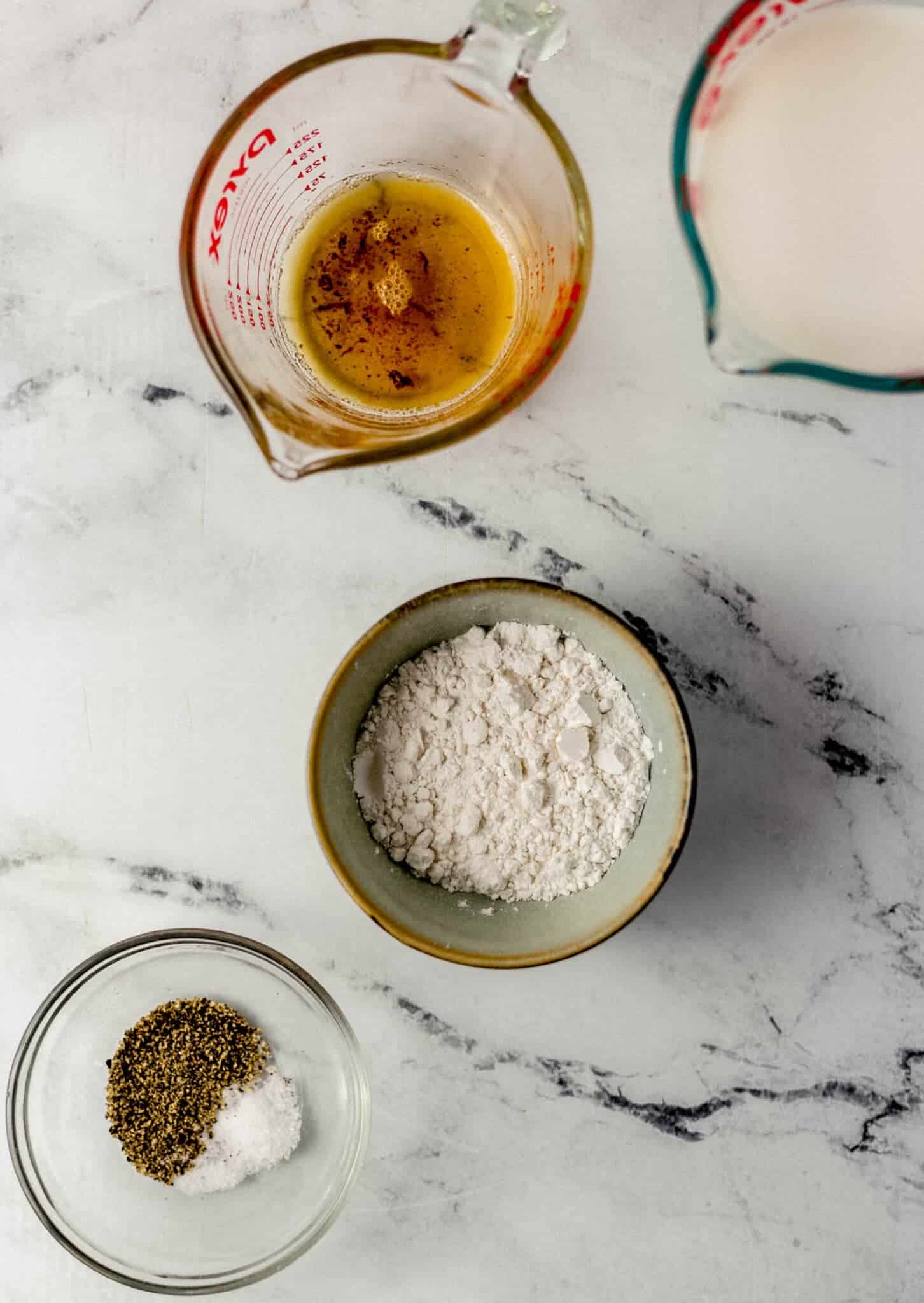 Overhead view of ingredients needed to make gravy in separate bowls