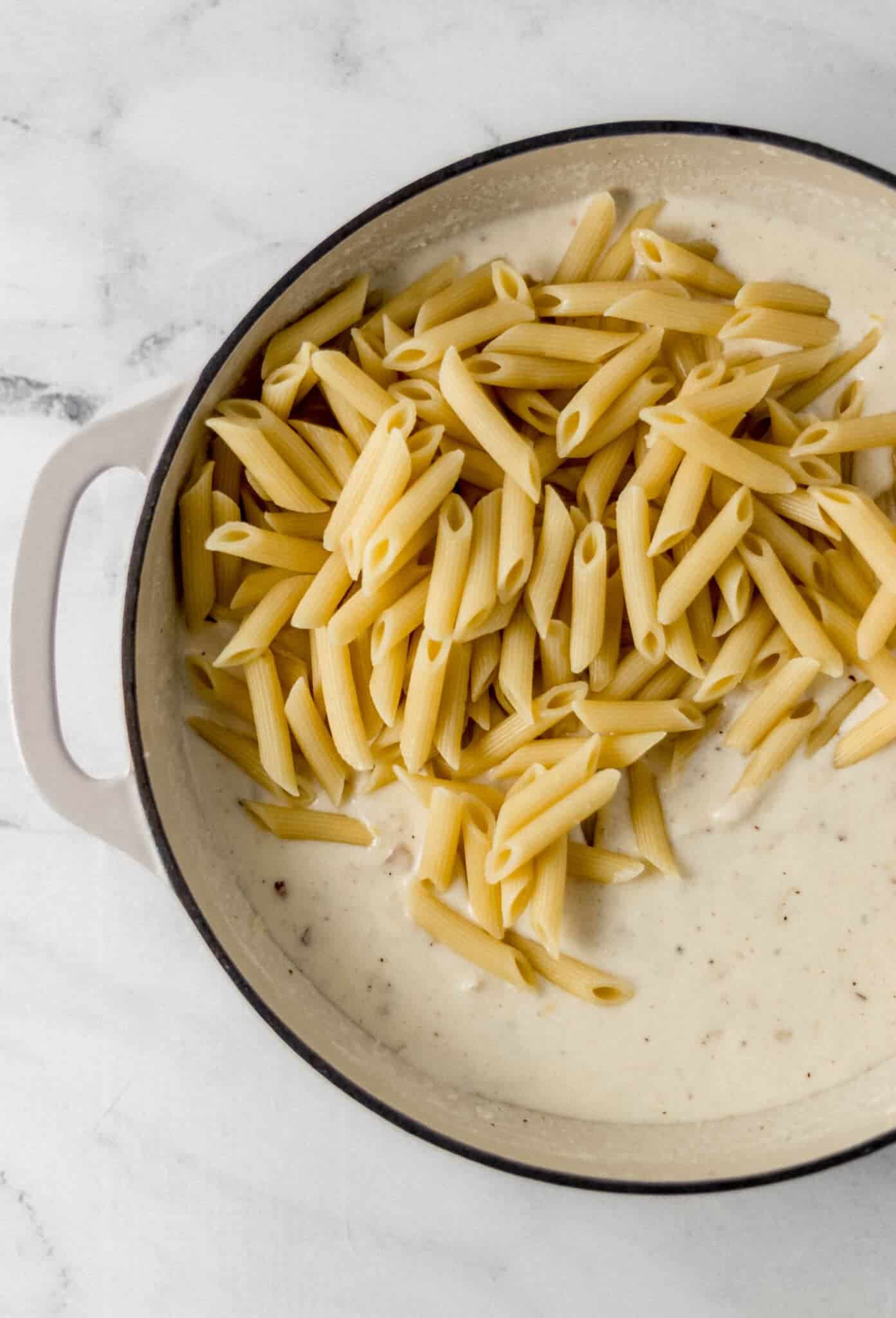 cooked pasta added to pan with sauce