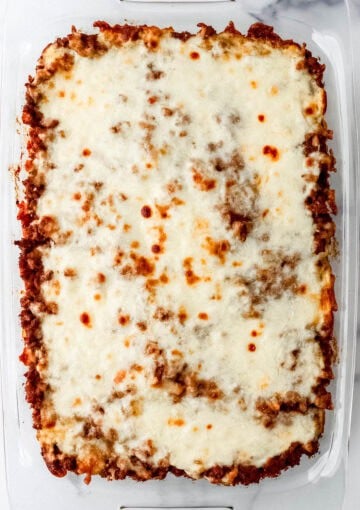 Overhead view of baked spaghetti in glass baking dish.