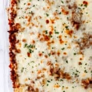 Close up overhead view of finished spaghetti in glass baking dish.
