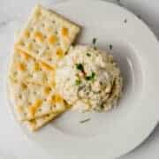 single serving of finished tuna salad on white plate with saltines