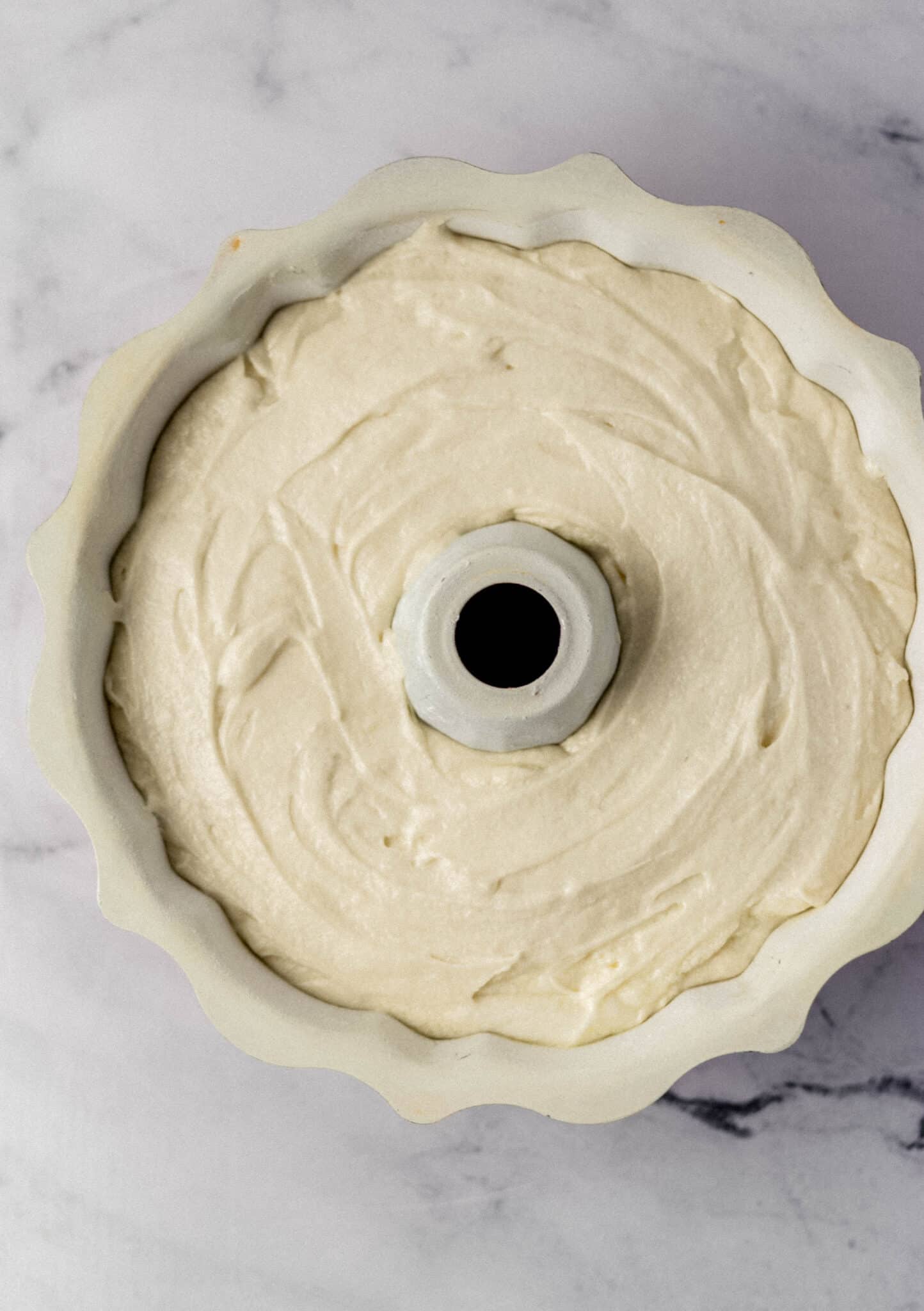 cake mixture added to prepared bundt pan before baking 