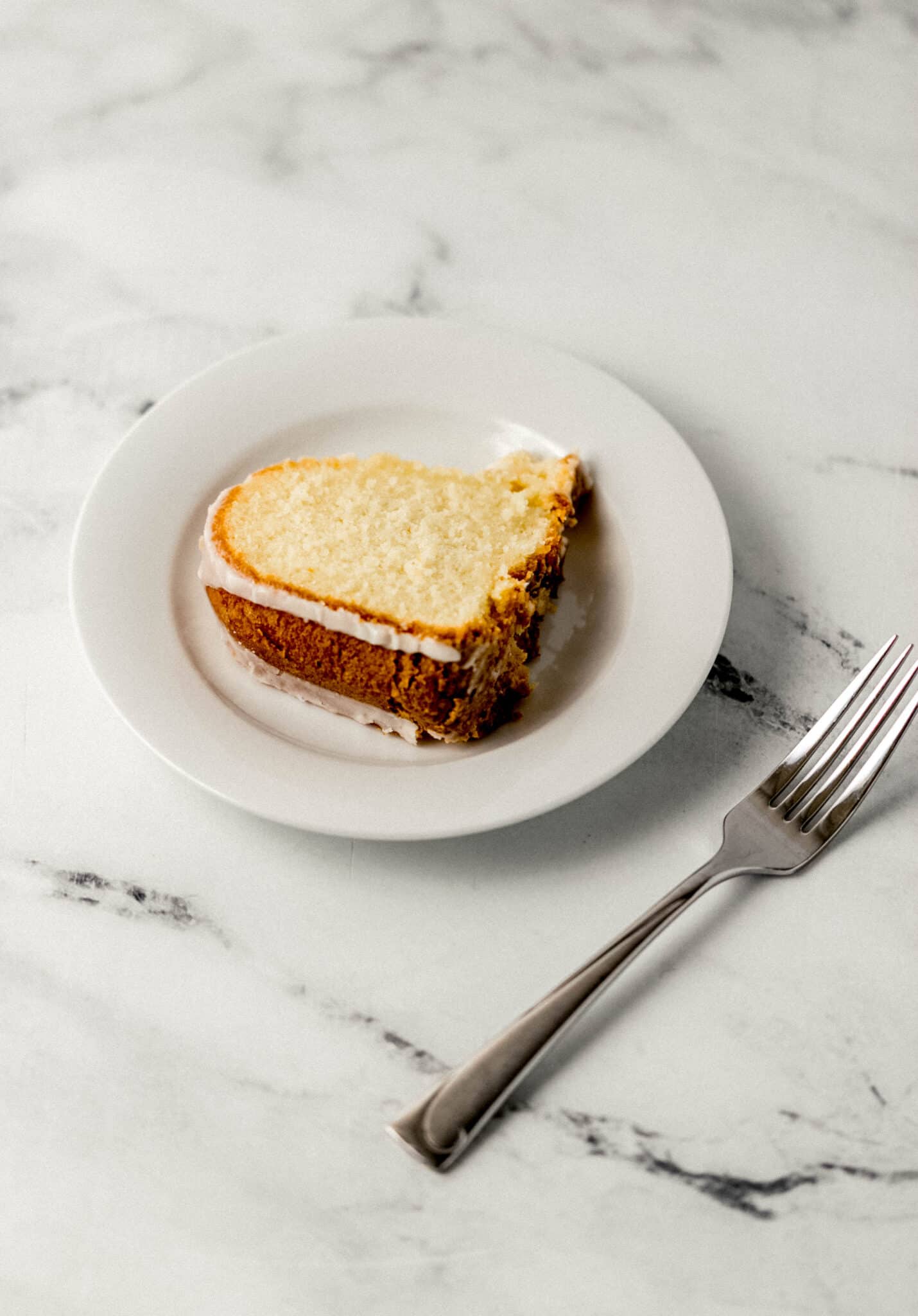slice of finished cake on white plate by a fork