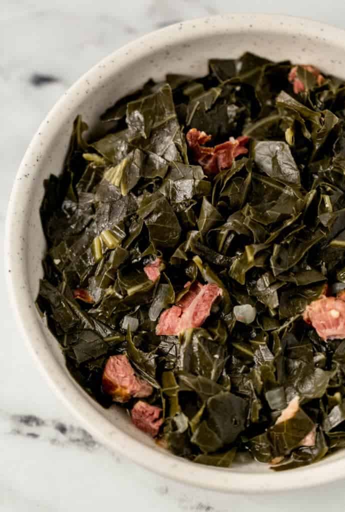 close up of finished greens in a white bowl