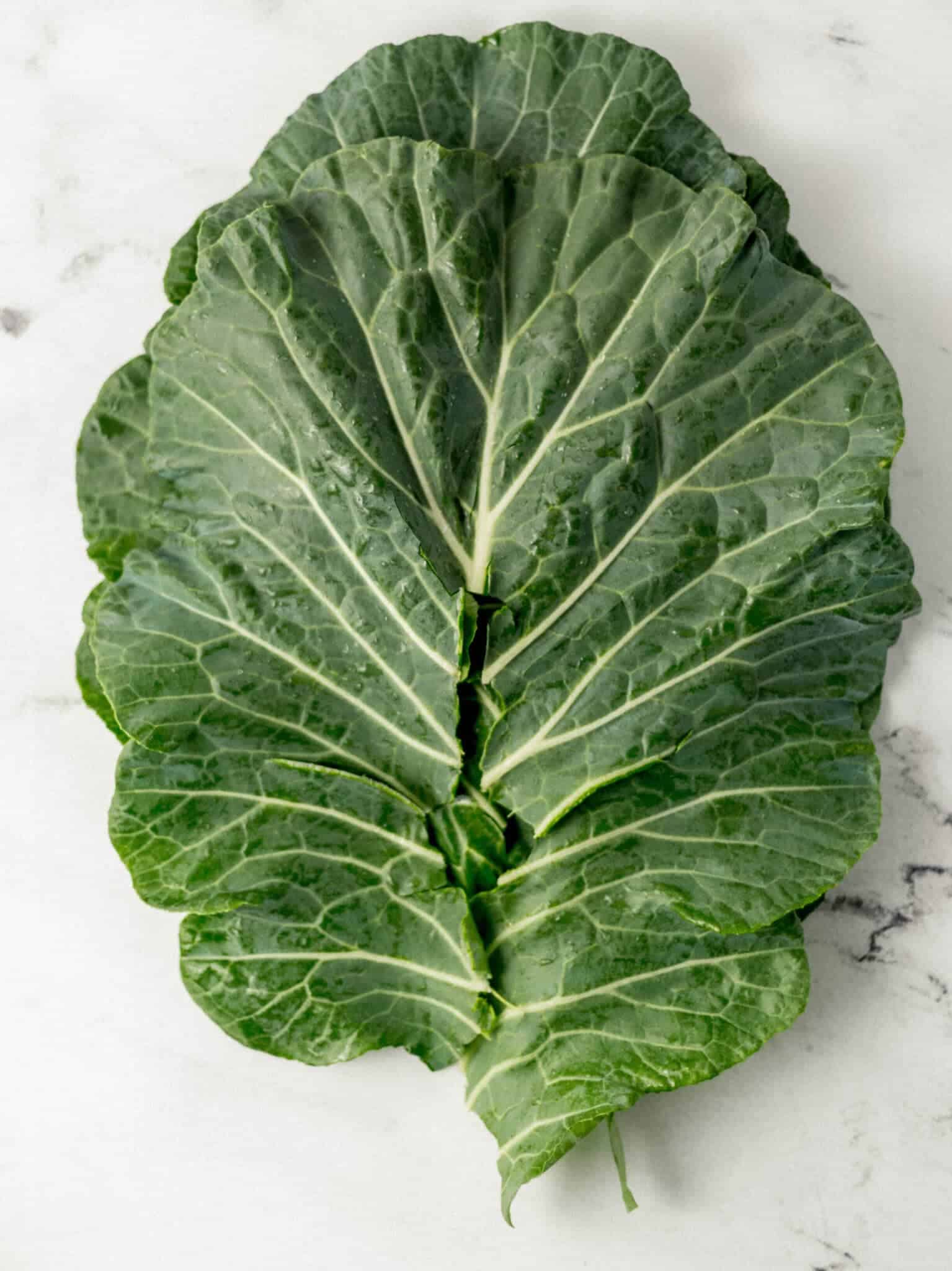 fresh collard greens stacked on top of each other 