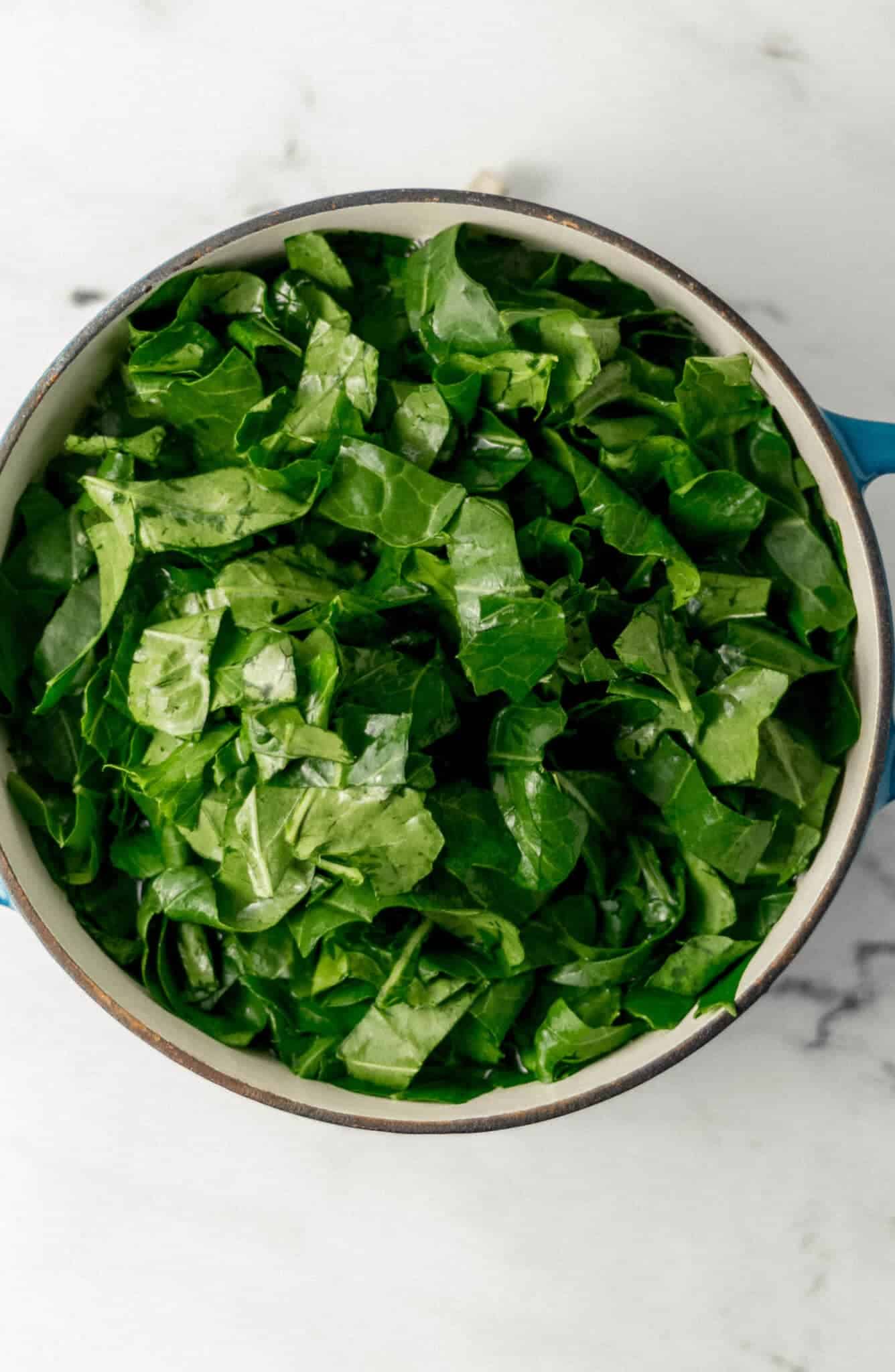 greens added to large pot with the other ingredients 