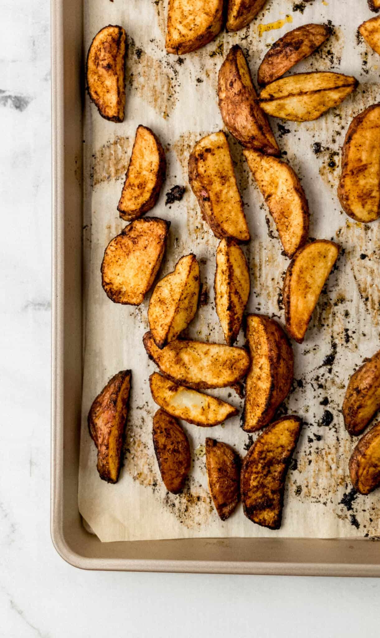 finished potatoes on parchment lined baking sheet 