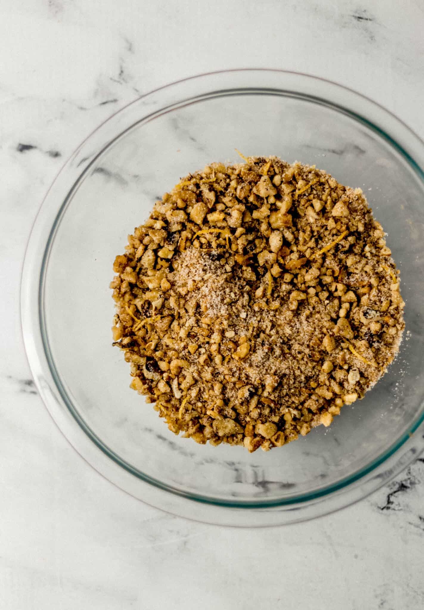 chopped walnut mixture in glass mixing bowl 