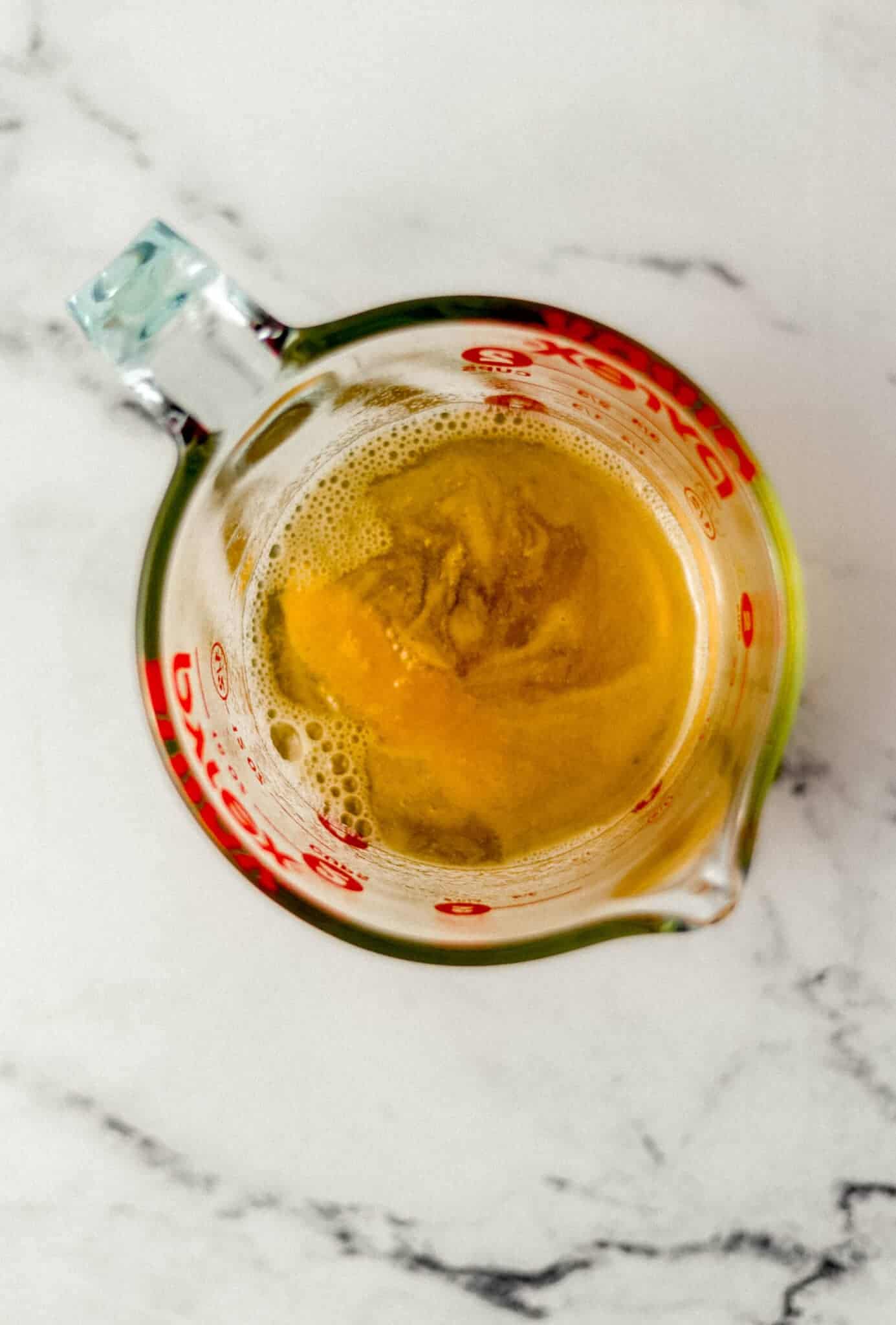 finished syrup in glass measuring cup 