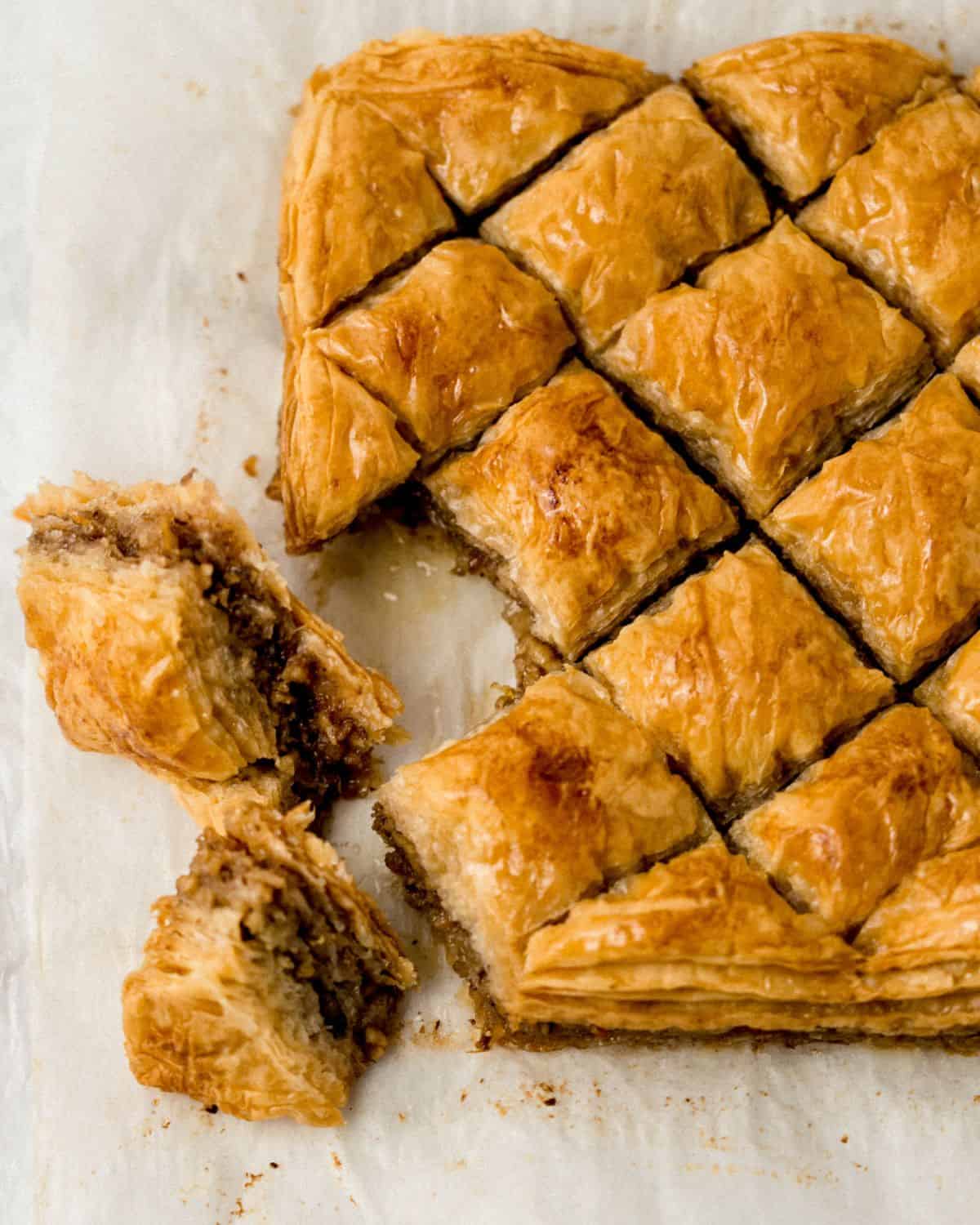 Overhead view of finished cut baklava on parchment paper.
