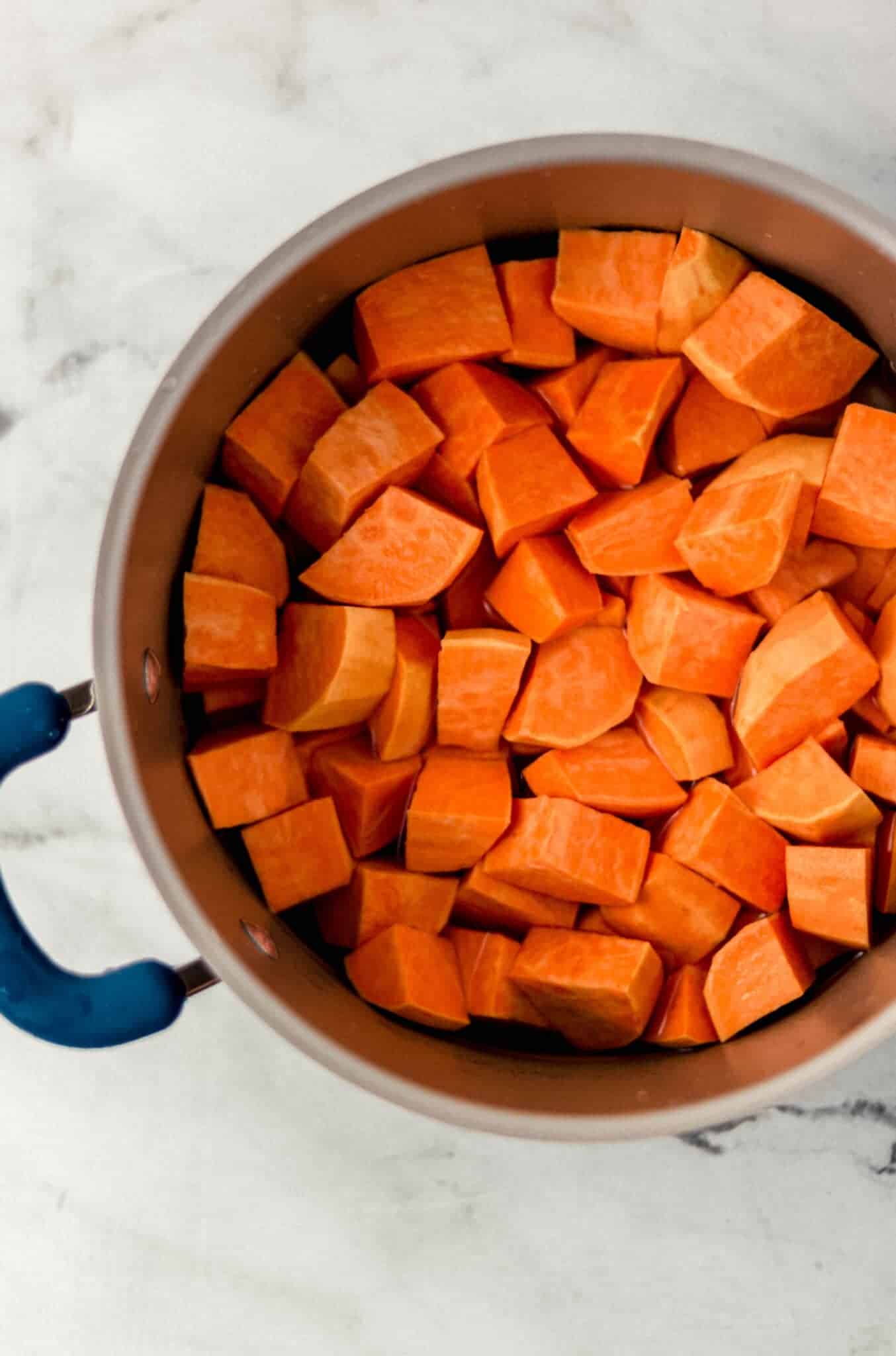 cut up sweet potatoes in large pot with water 