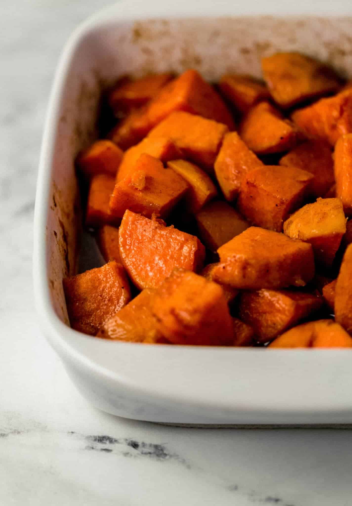 close up view of finished yams in baking dish 