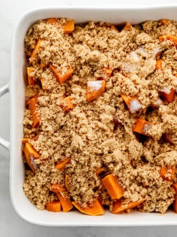 Cane sugar and brown sugar added to the sweet potatoes in the baking dish.