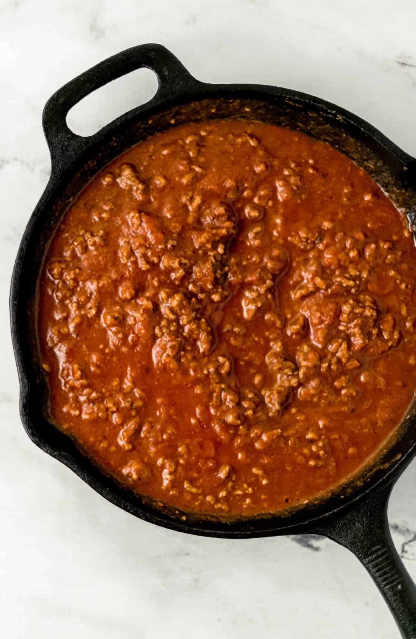 meat sauce for lasagna in a cast iron skillet 