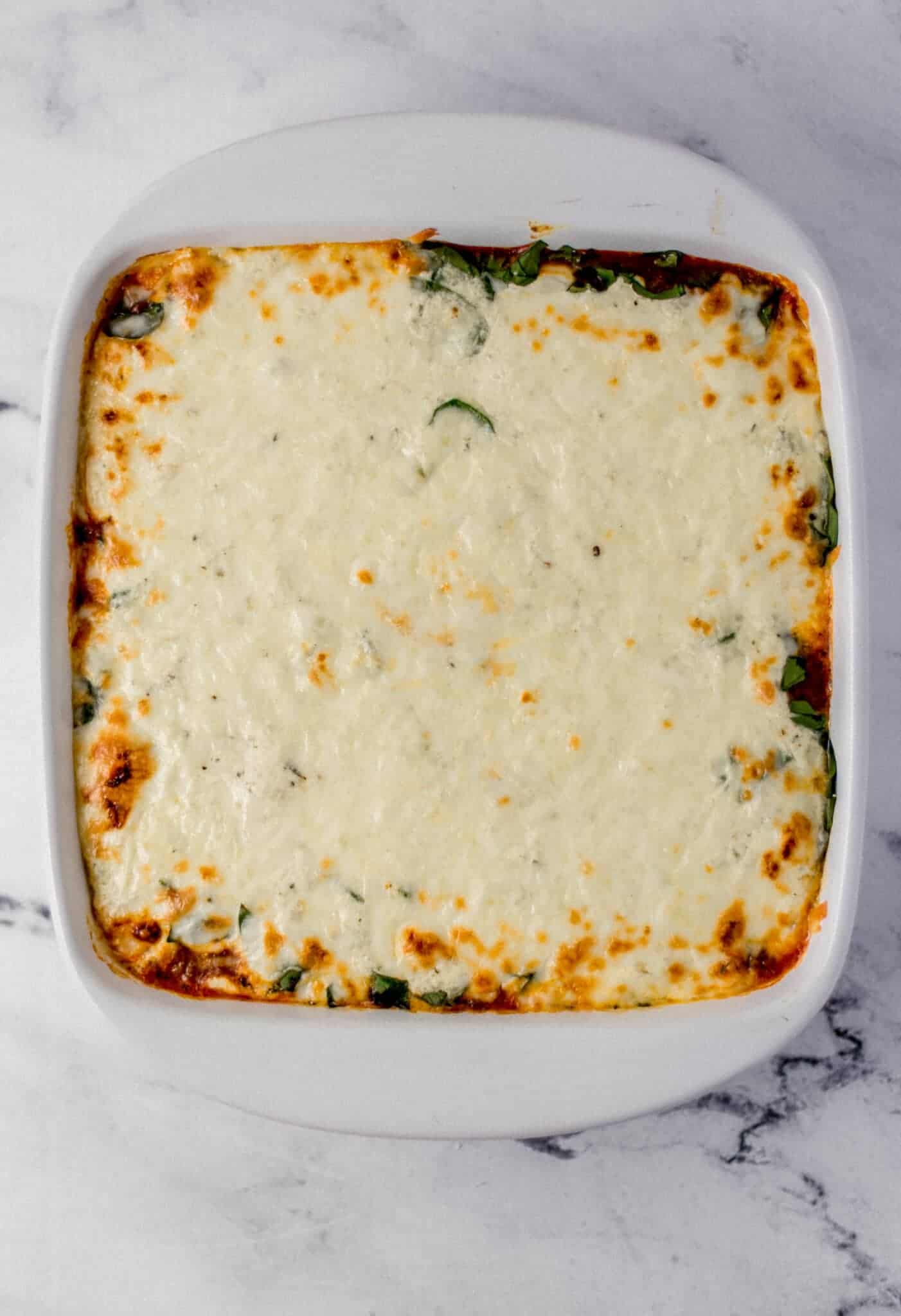overhead view of baked lasagna in baking dish 