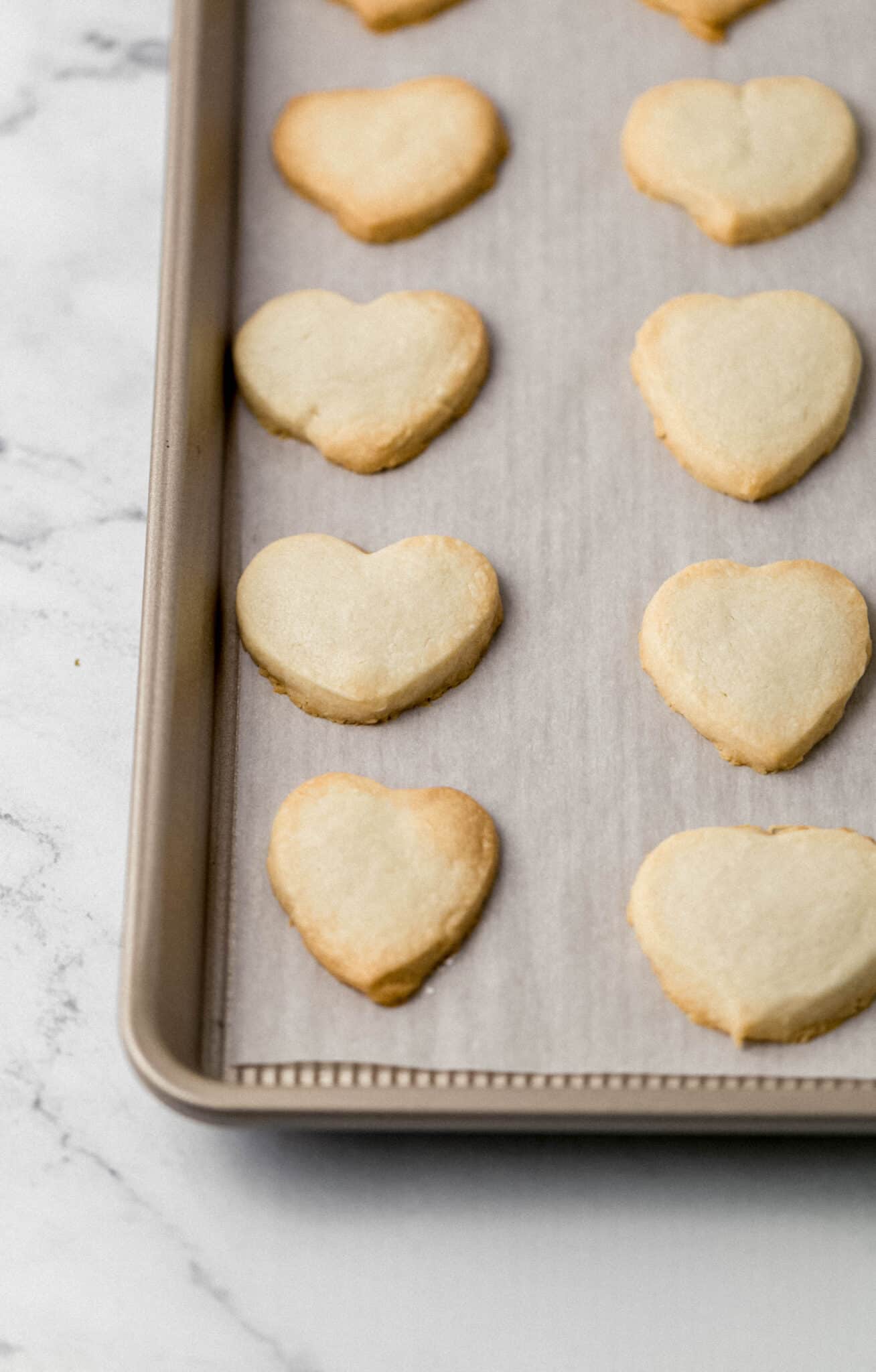 shortbread cookies on parchment lined baking sheet after baking 