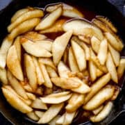 Overhead view of finished fried apples in cast iron skillet.