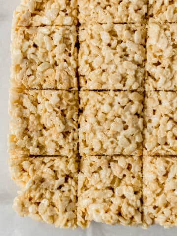 overhead view of crispy treats cut into squares on parchement paper