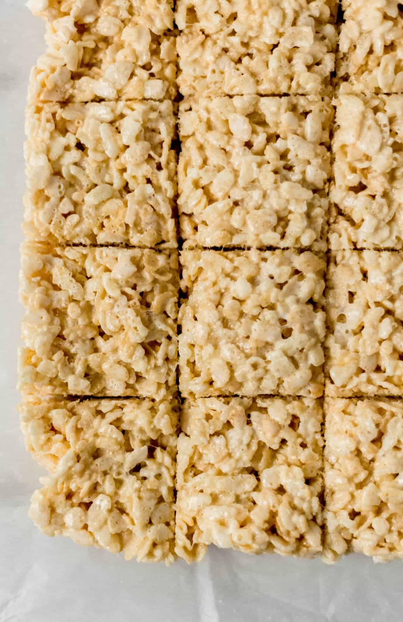 overhead view of finished rice crispy treats on parchment paper 