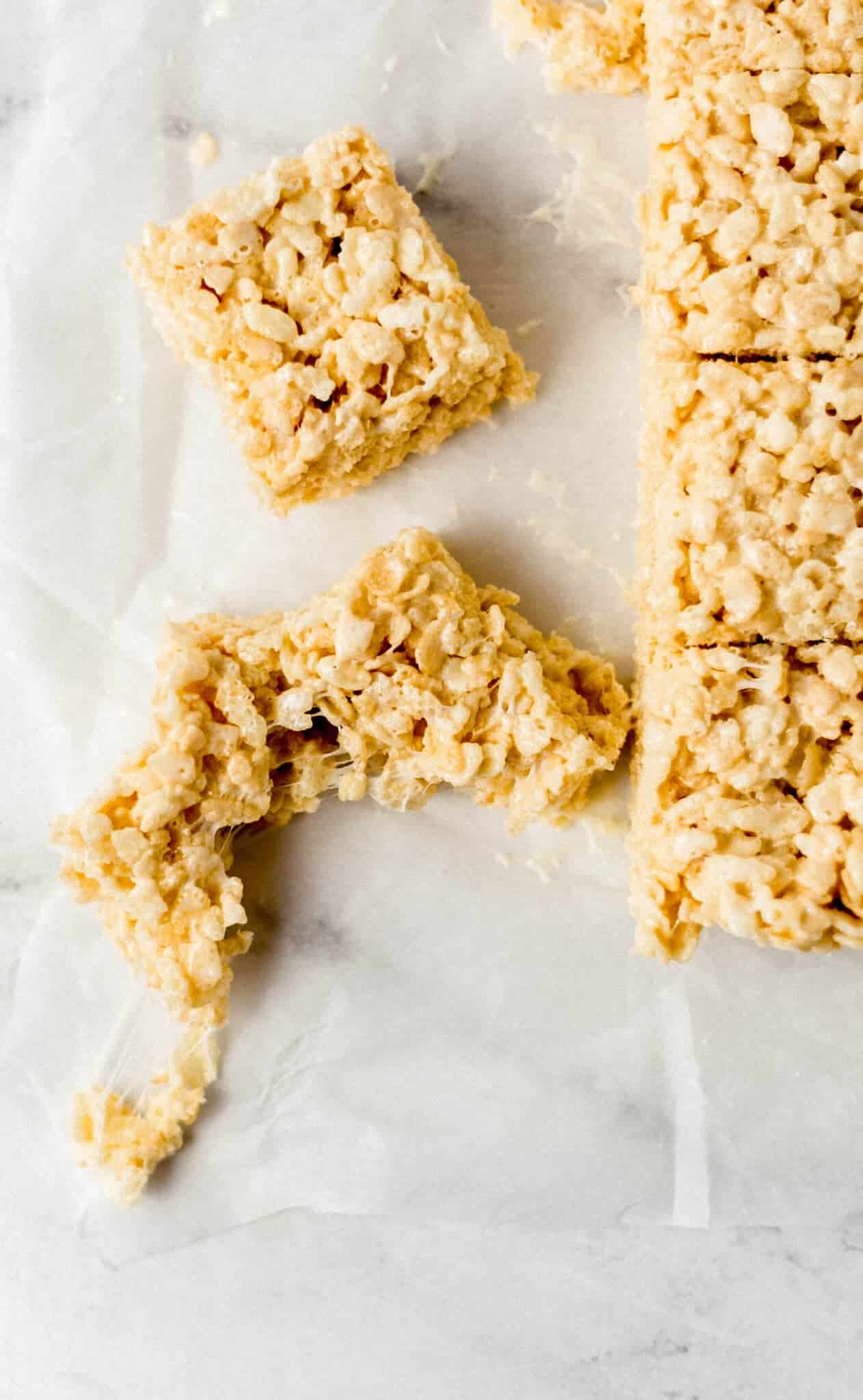 cut up rice crispy treats on parchment paper 