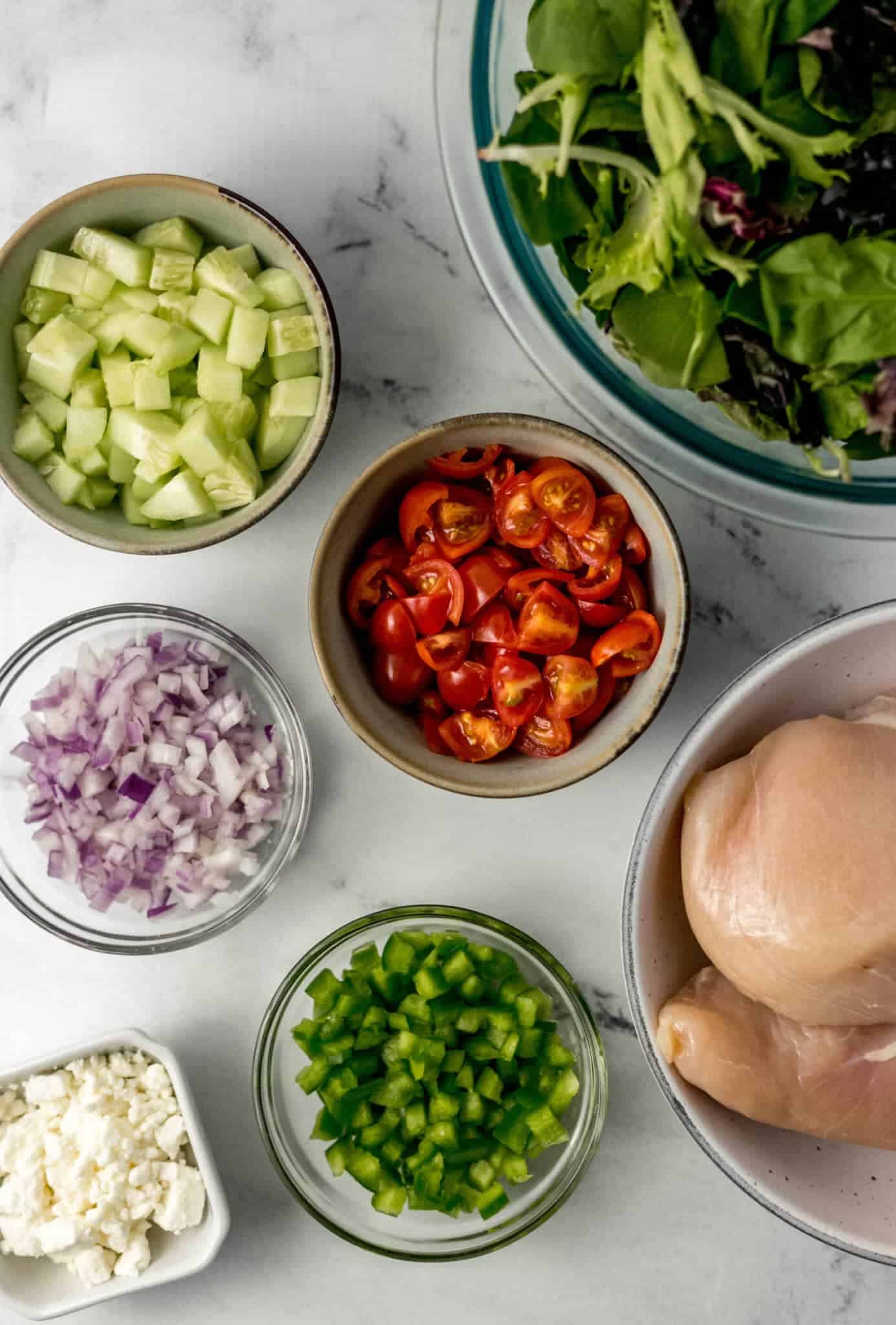 overhead view of salad ingredients in separate bowls