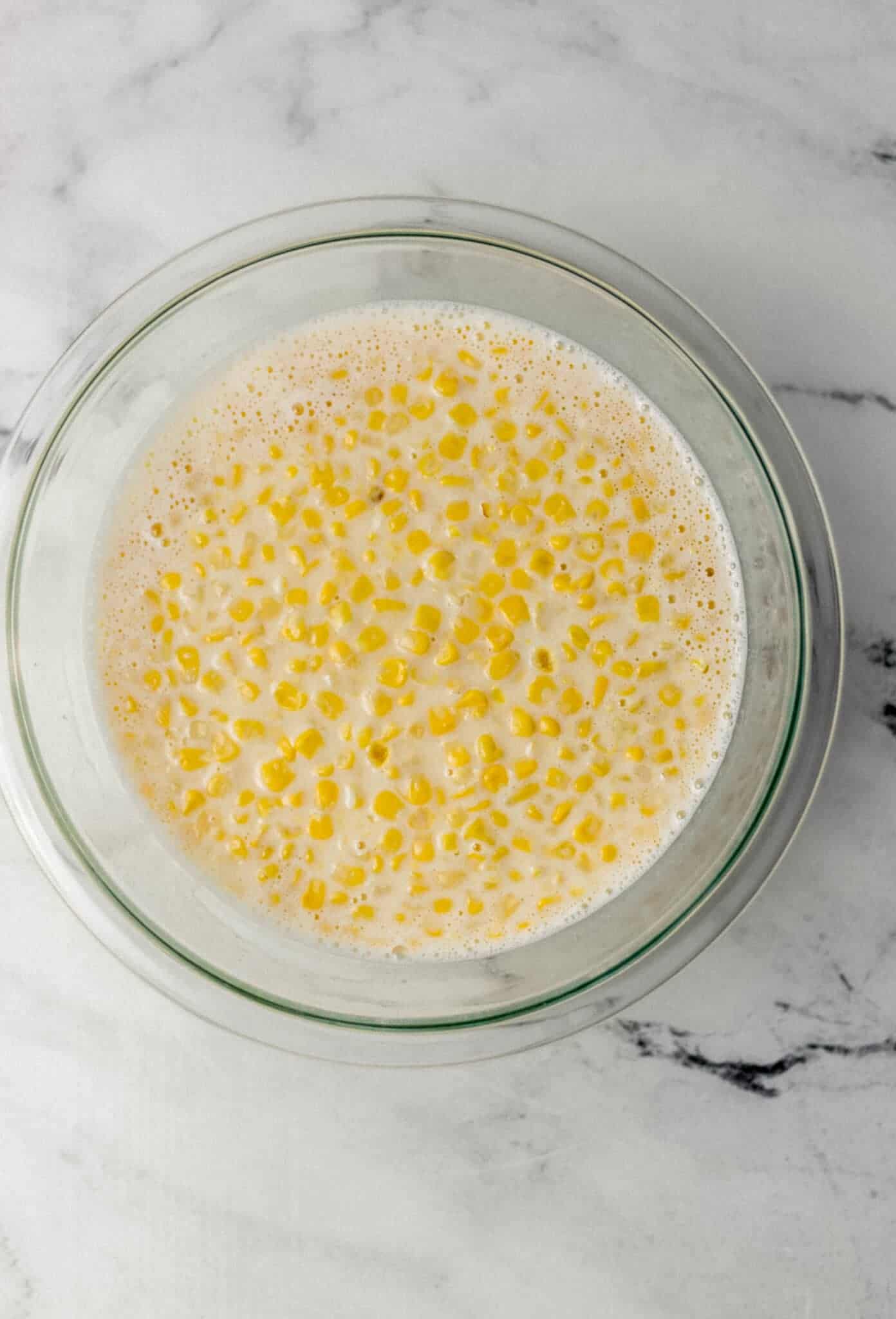 milk, corn, and salt added to glass mixing bowl with the rest of the pudding ingredients 