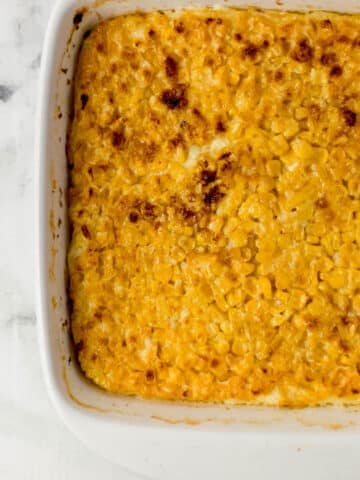 overhead view of finished corn pudding in white baking dish