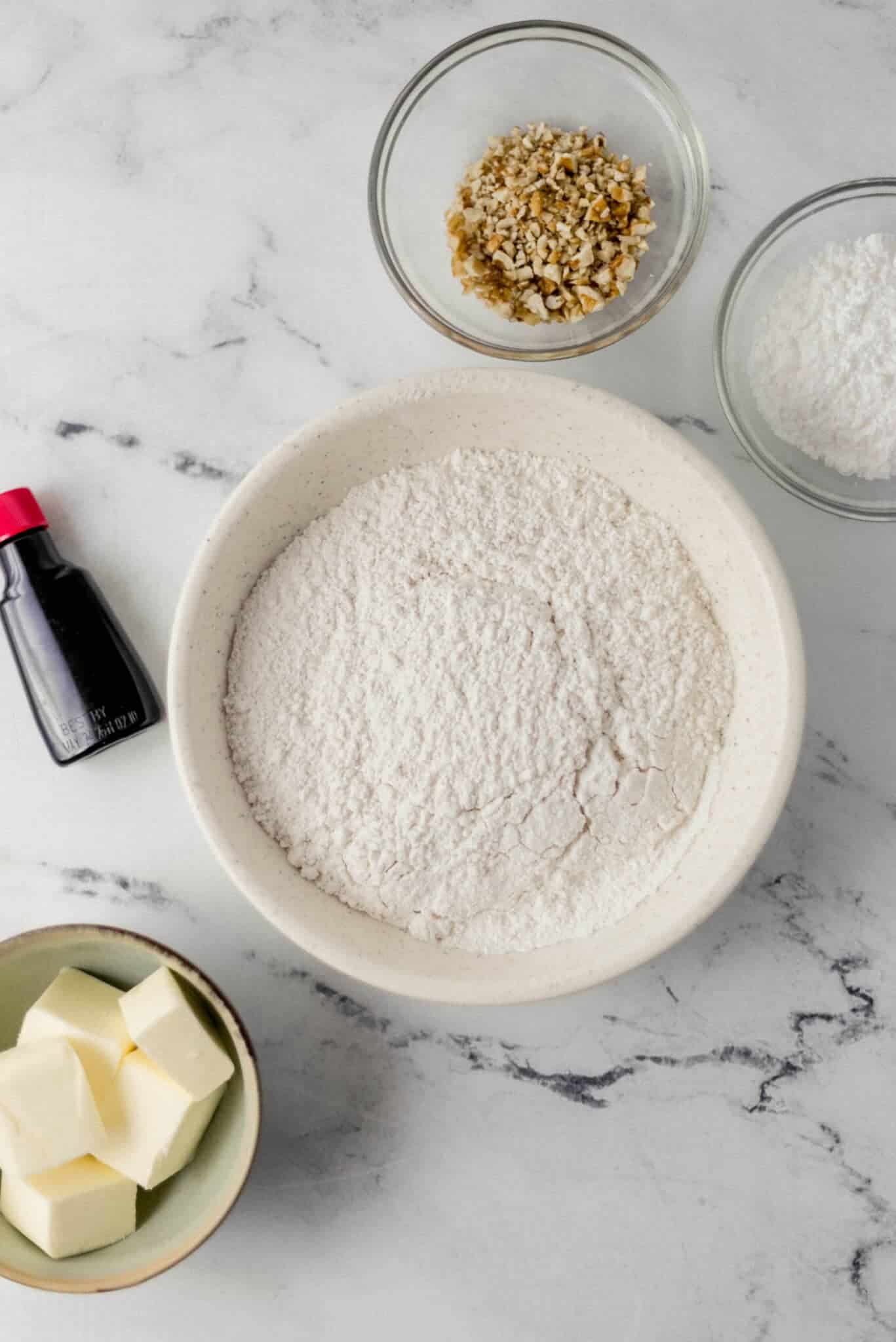 overhead view of ingredients needed to make tea cakes in separate bowls 