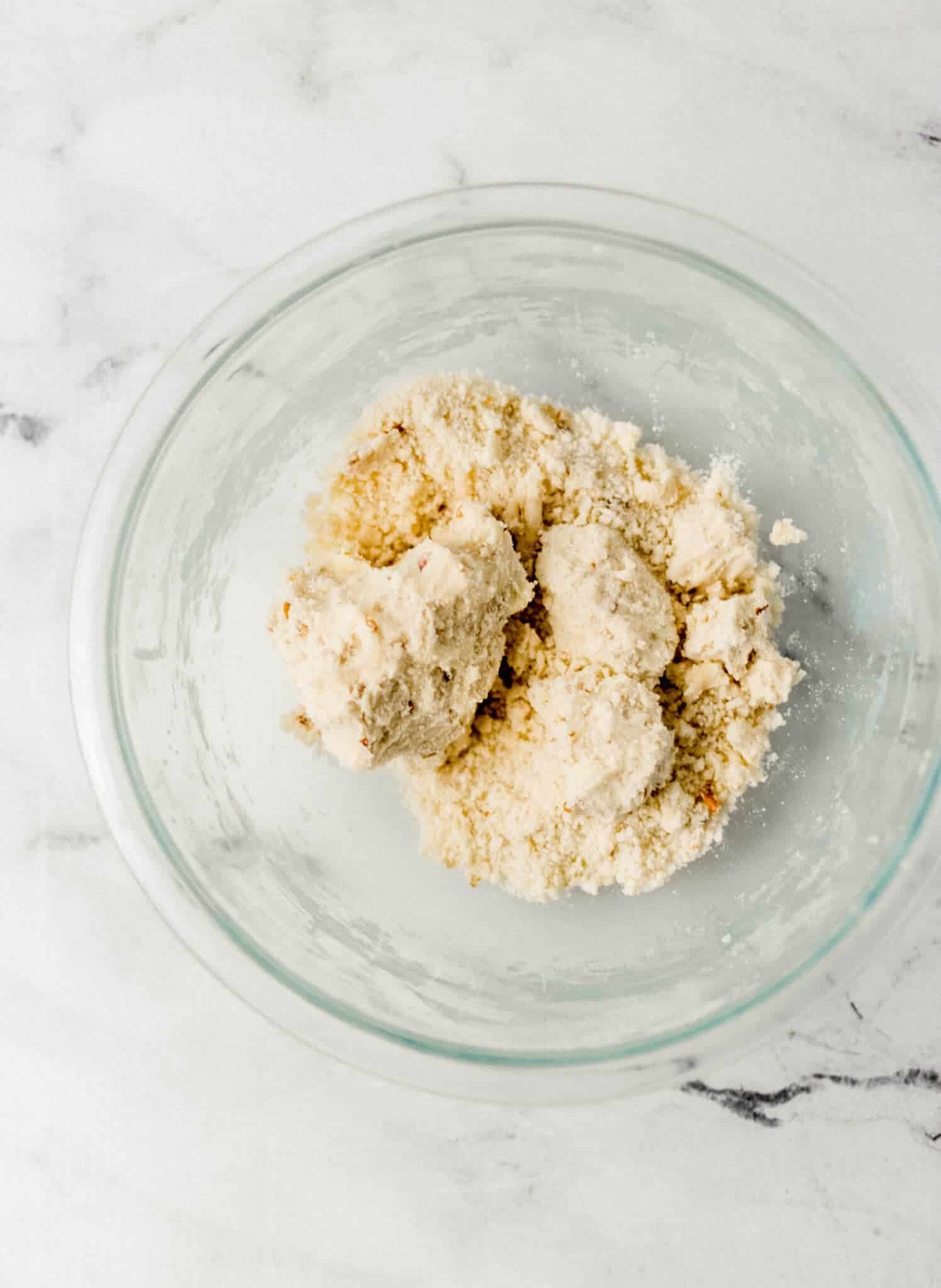 all ingredients to make tea cakes combined in glass mixing bowl 