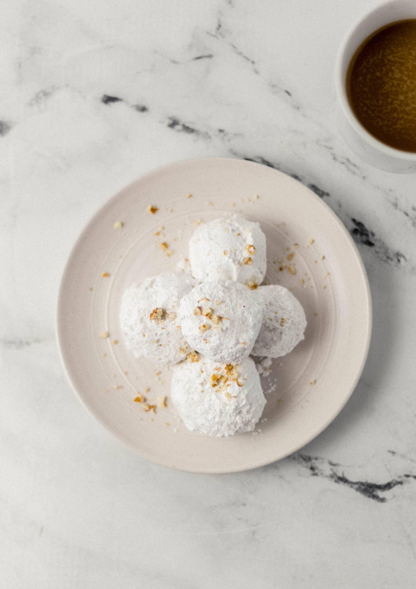 overhead view of finished tea cakes on white plate 