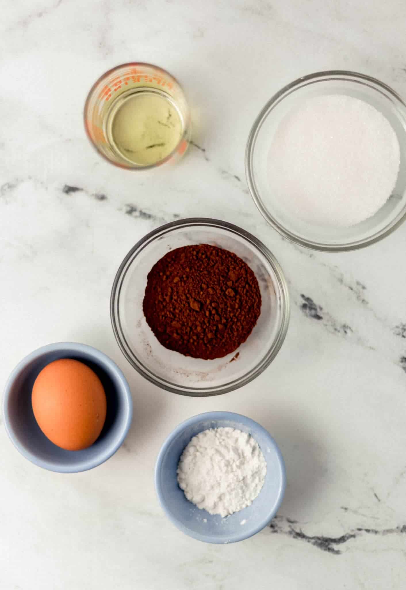 overhead view of ingredients needed to make brownie in separate small bowls 