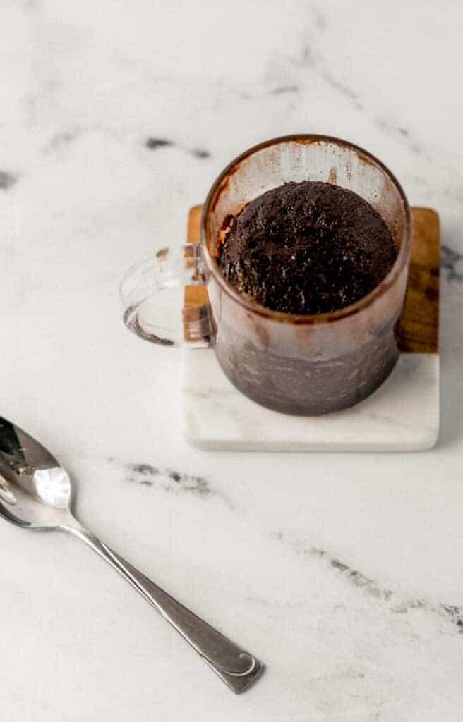 overhead view of finished brownie on top of a coaster by a spoon