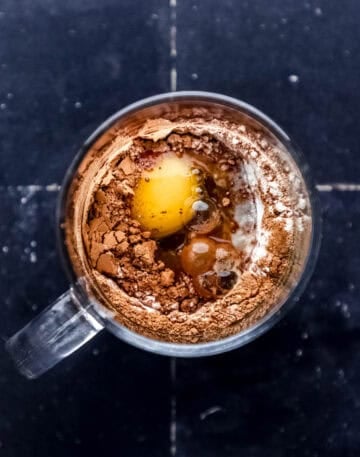 Brownie ingredients added to glass mug.